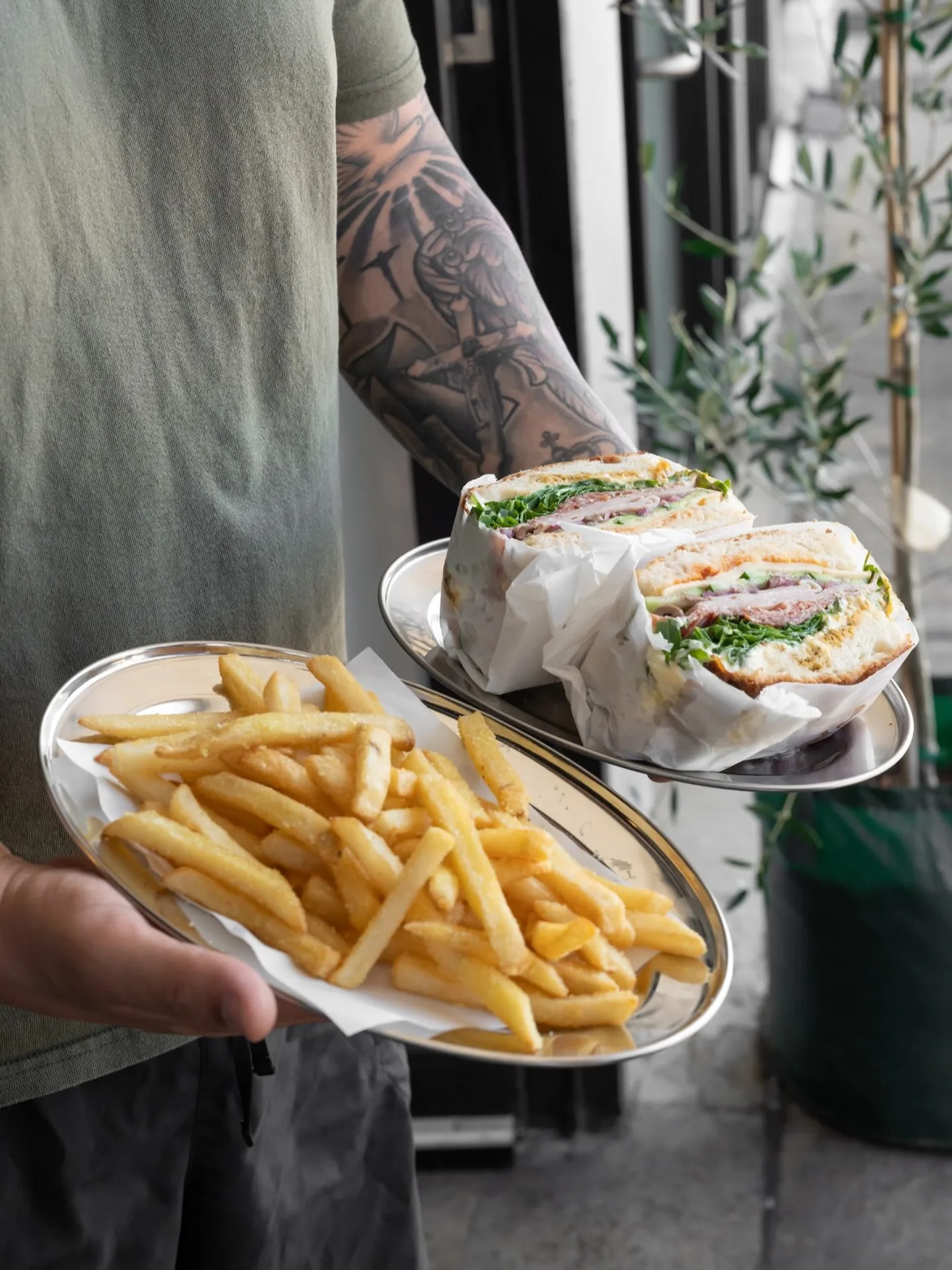 Focaccias and fries on steel trays, carried out from the counter