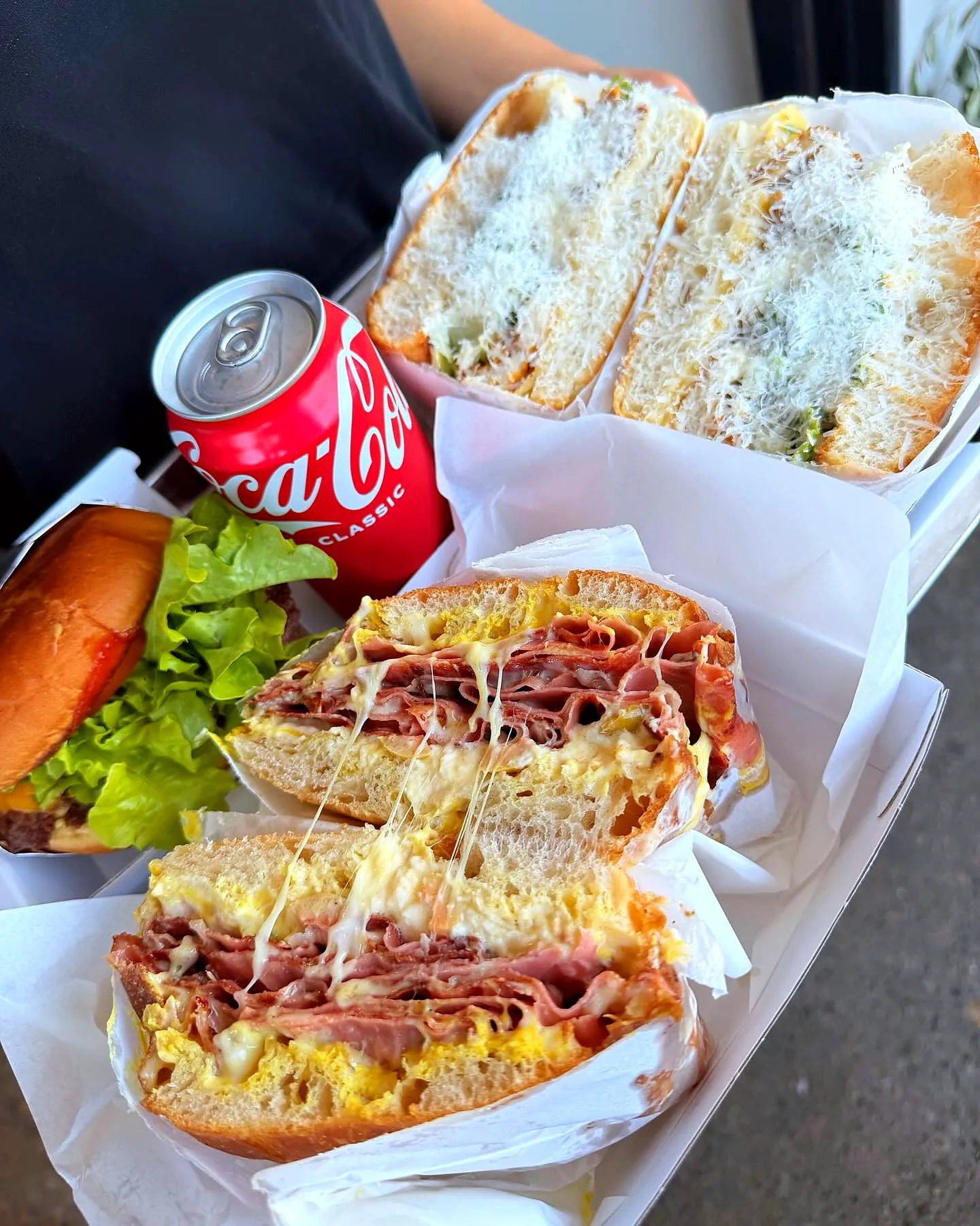 Two focaccias cut open with a can of Coke